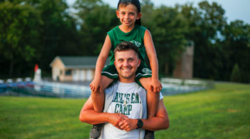 camper on shoulders for trails end camp